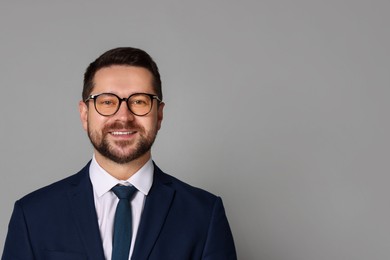 Photo of Portrait of banker in glasses on grey background, space for text