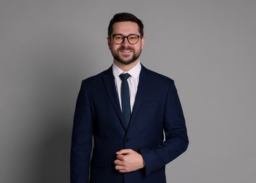 Photo of Portrait of banker in glasses on grey background