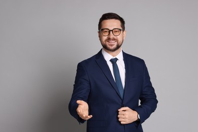 Portrait of banker in glasses on grey background