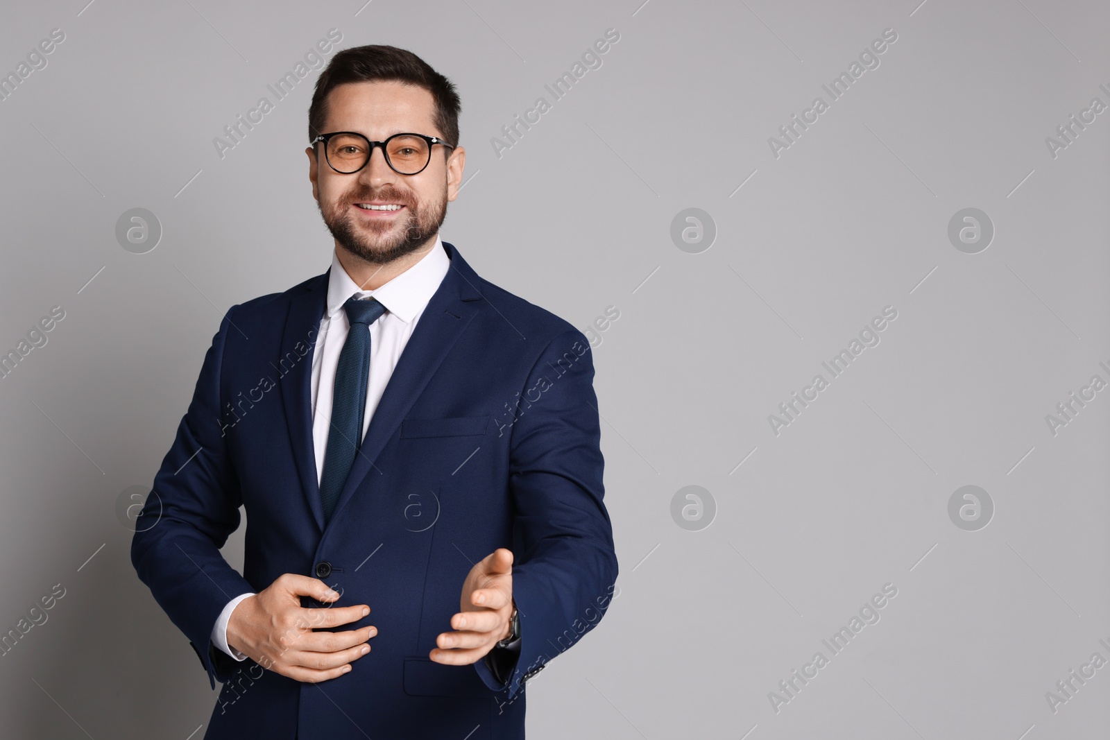 Photo of Portrait of banker in glasses on grey background, space for text