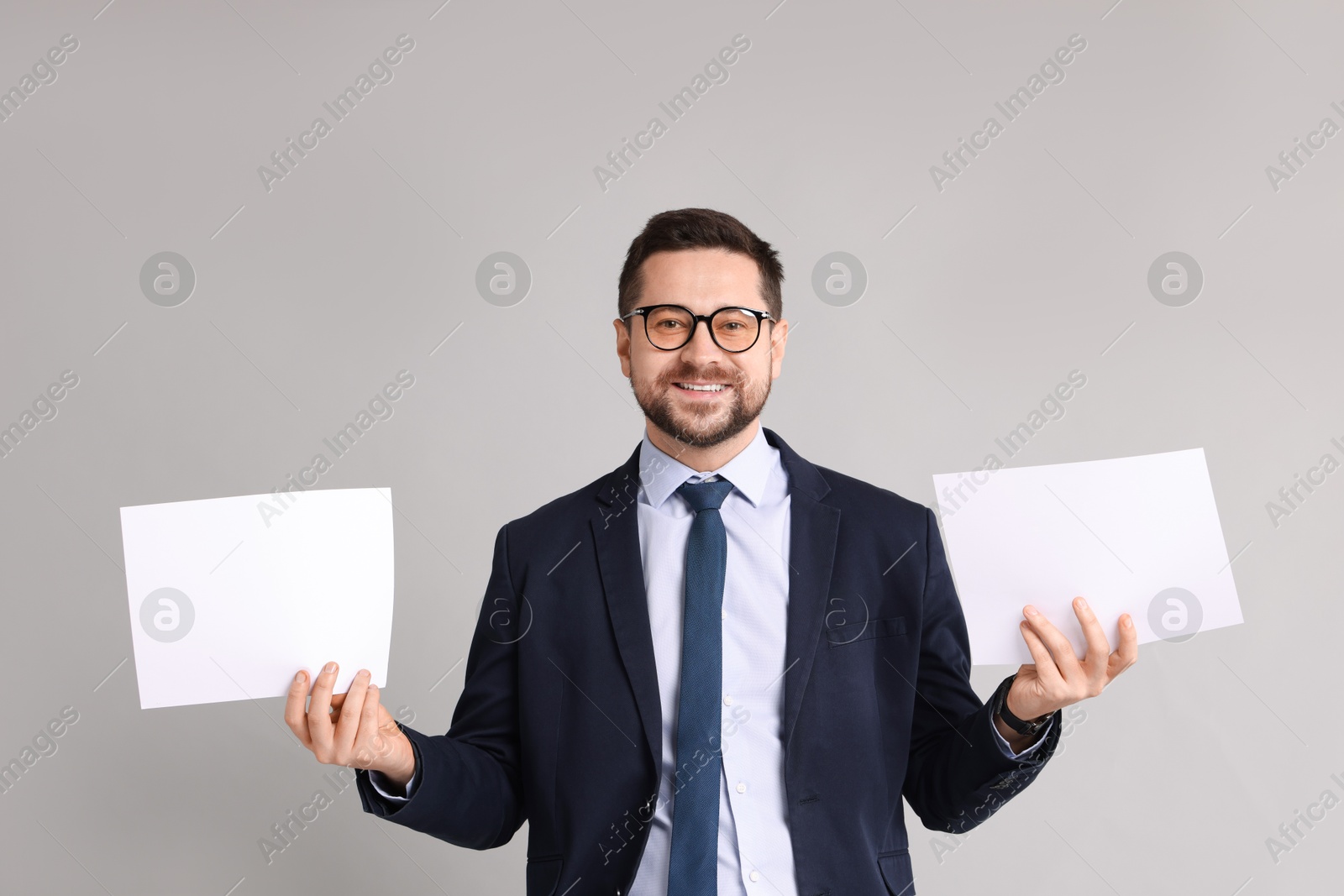 Photo of Portrait of banker with documents on grey background