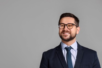 Photo of Portrait of banker in glasses on grey background, space for text