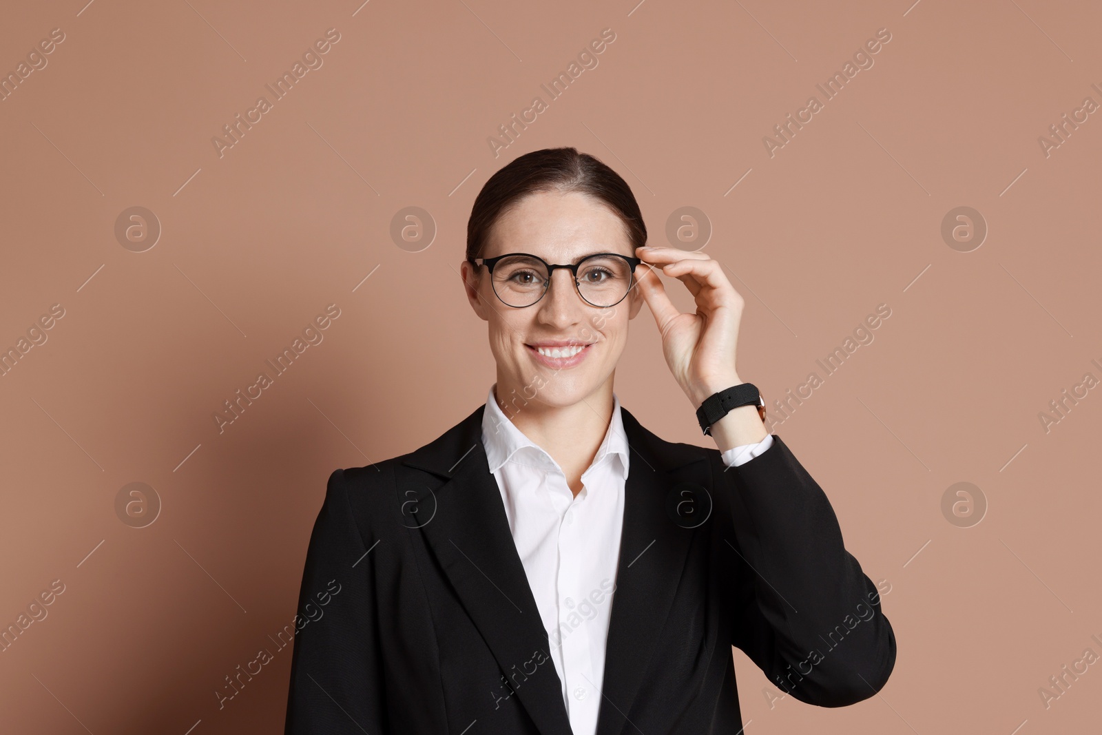 Photo of Portrait of banker in glasses on brown background