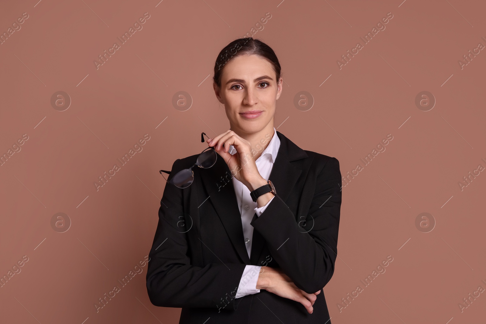 Photo of Portrait of banker with glasses on brown background