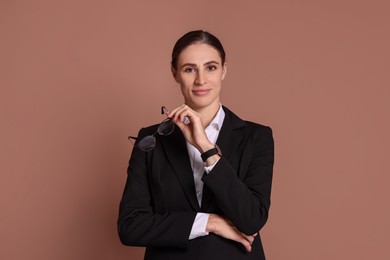 Photo of Portrait of banker with glasses on brown background