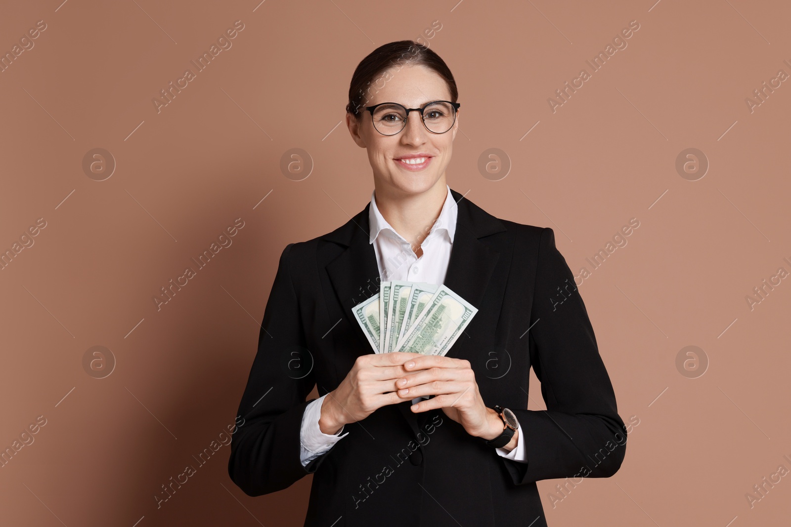 Photo of Banker with dollar banknotes on brown background