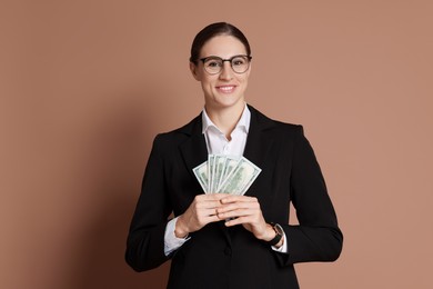 Photo of Banker with dollar banknotes on brown background