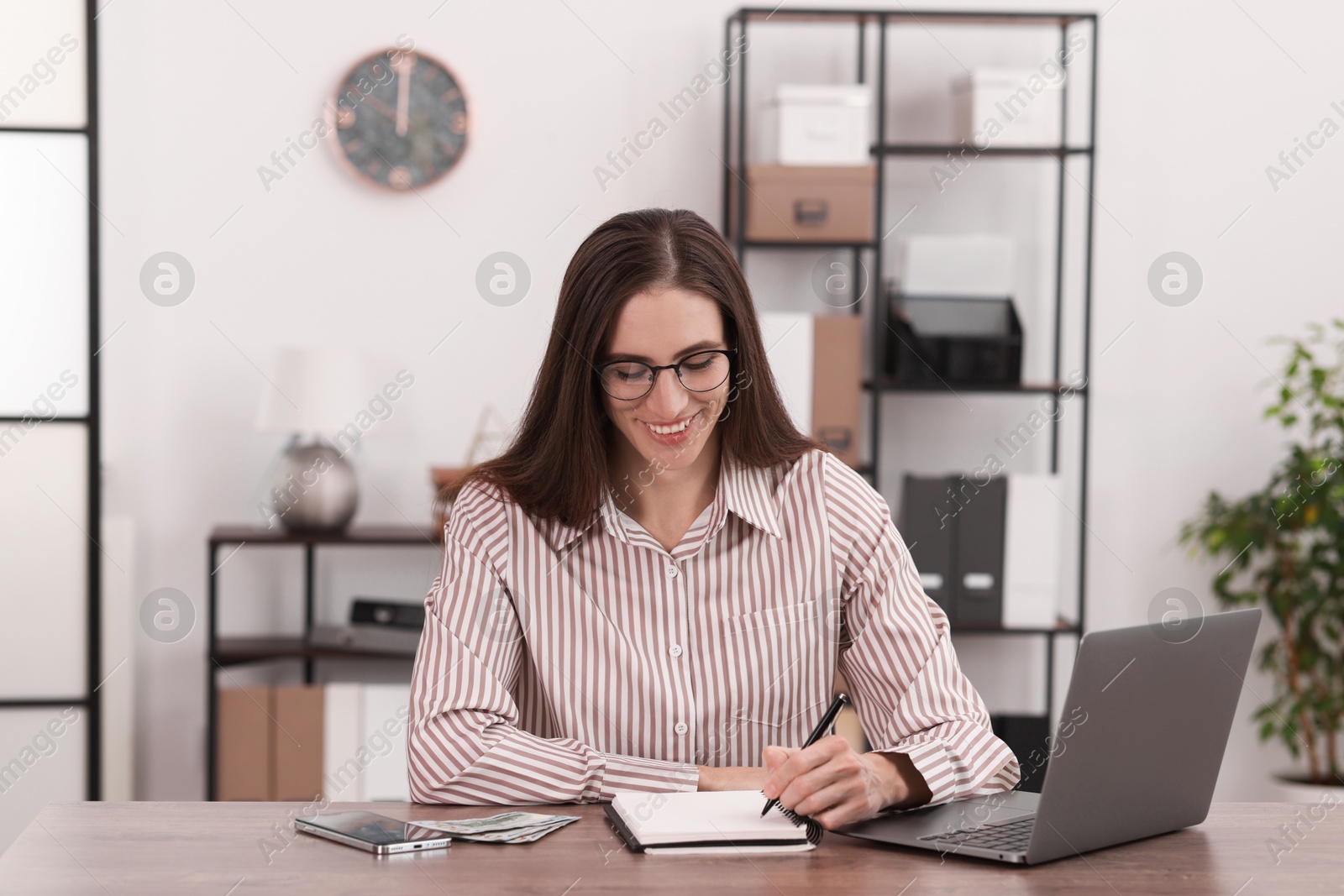 Photo of Banker working at wooden table in office