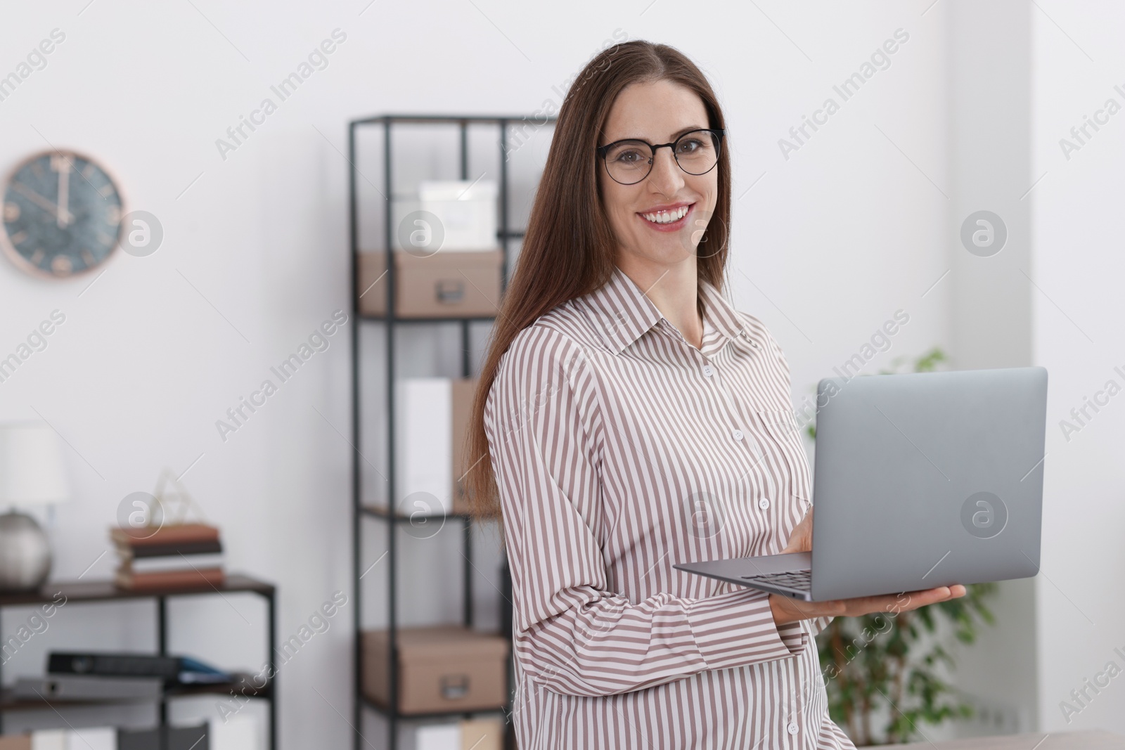 Photo of Banker with glasses using laptop in office. Space for text