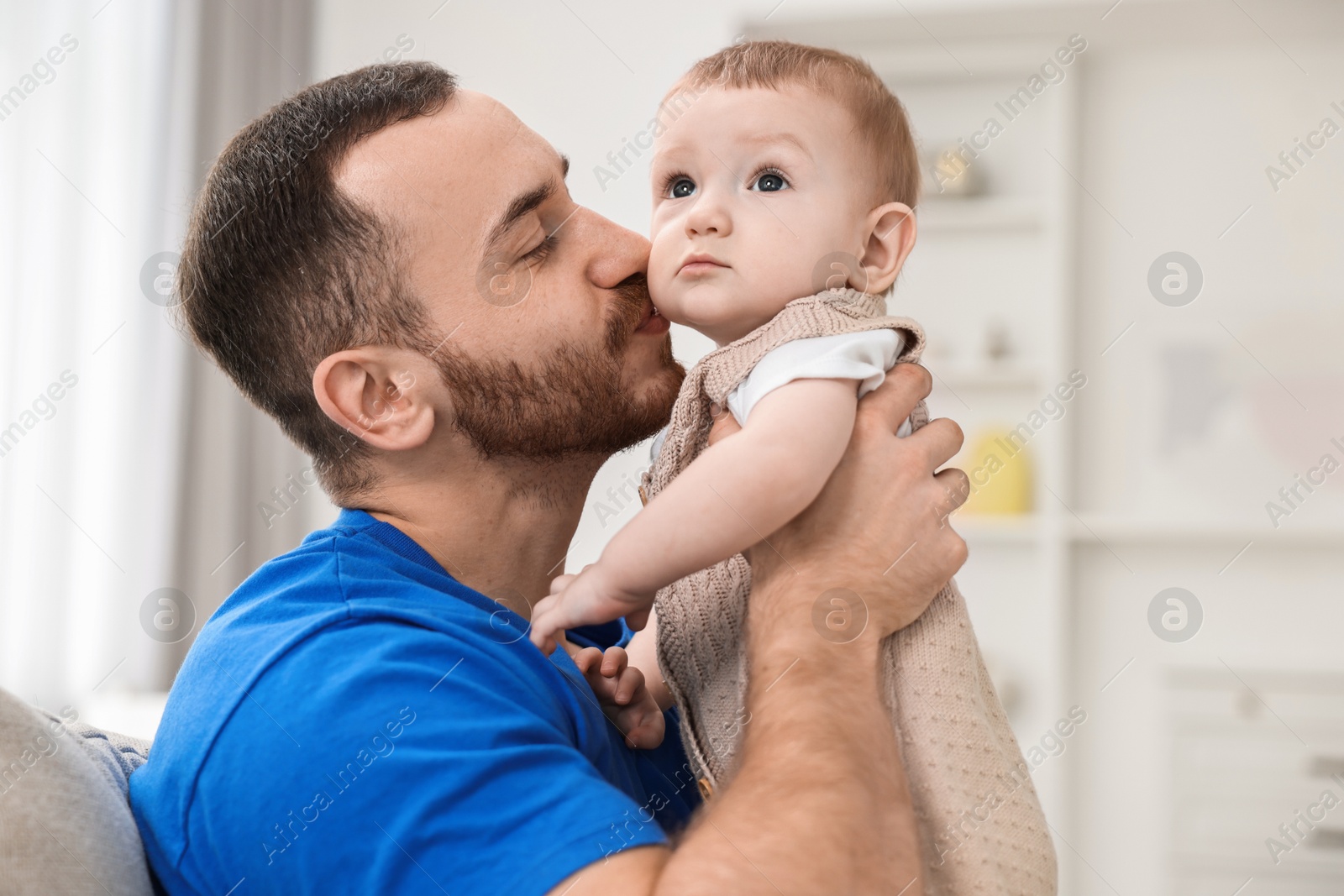 Photo of Dad with his cute little baby at home