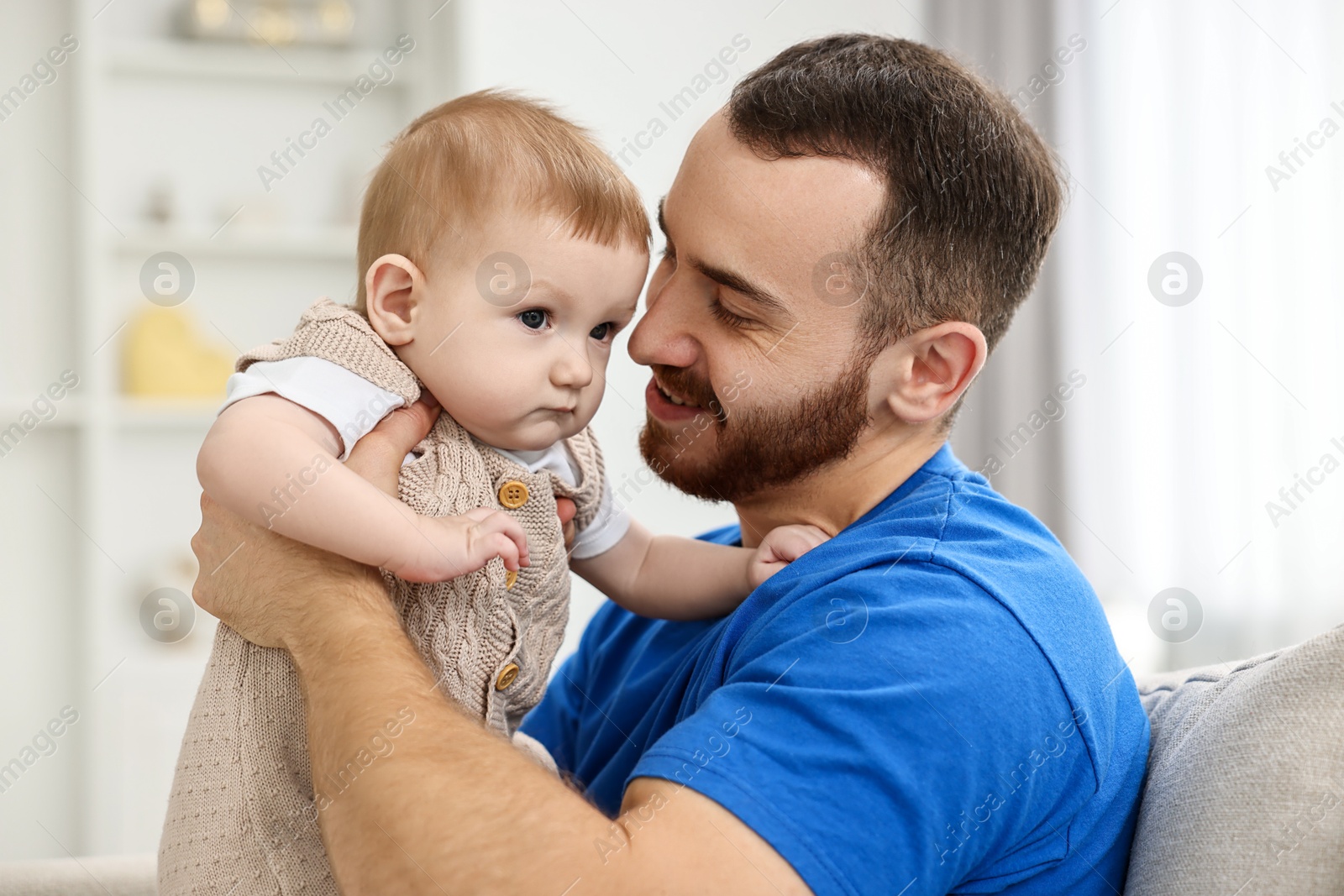 Photo of Dad with his cute little baby at home