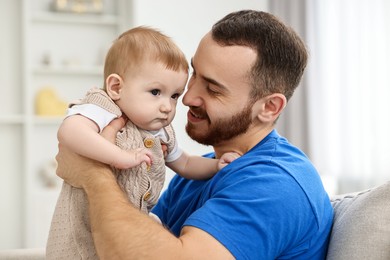 Photo of Dad with his cute little baby at home