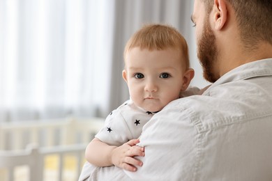 Photo of Dad with his cute little baby at home, closeup. Space for text