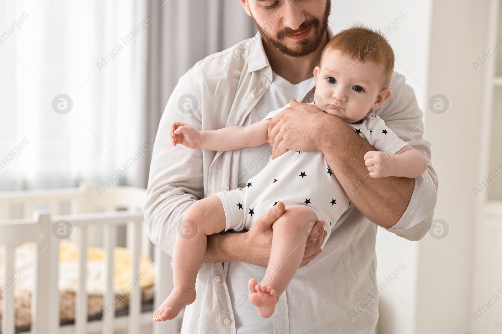 Photo of Dad with his cute little baby at home, closeup