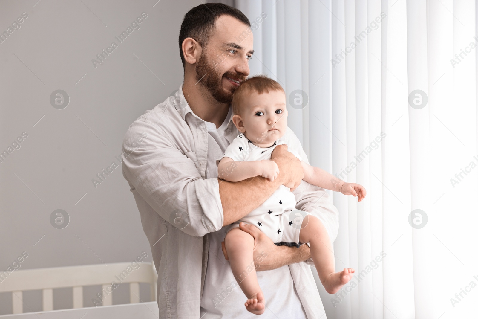 Photo of Dad with his cute little baby at home