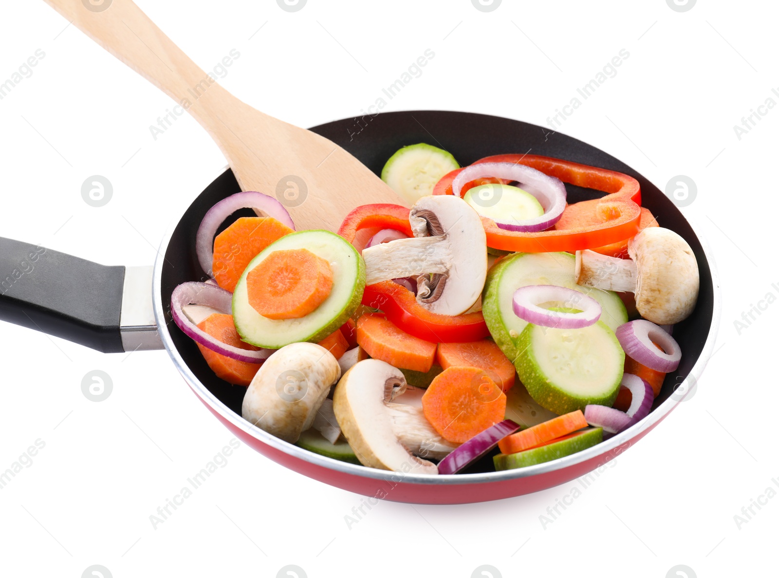 Photo of Frying pan with mix of fresh vegetables, mushrooms and spatula isolated on white