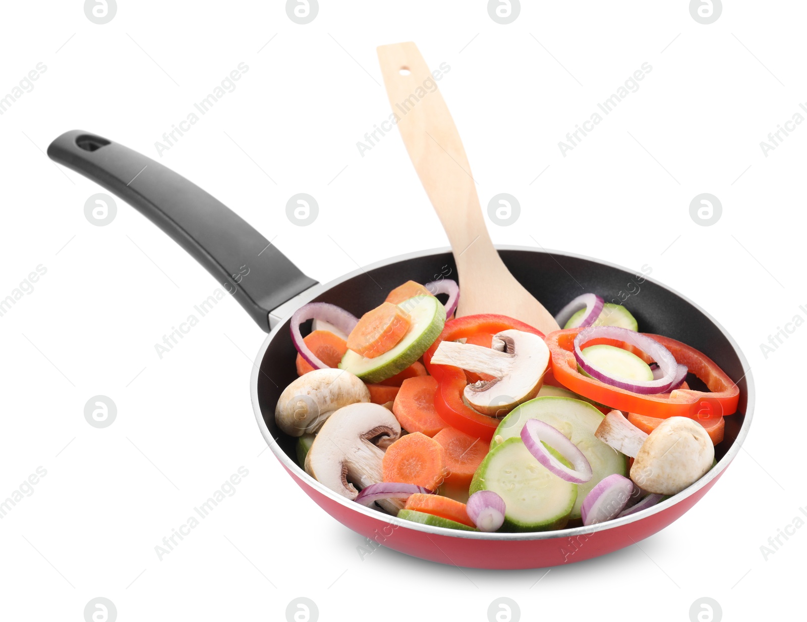 Photo of Frying pan with mix of fresh vegetables, mushrooms and spatula isolated on white