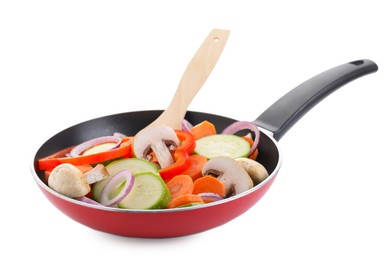 Photo of Frying pan with mix of fresh vegetables, mushrooms and spatula isolated on white