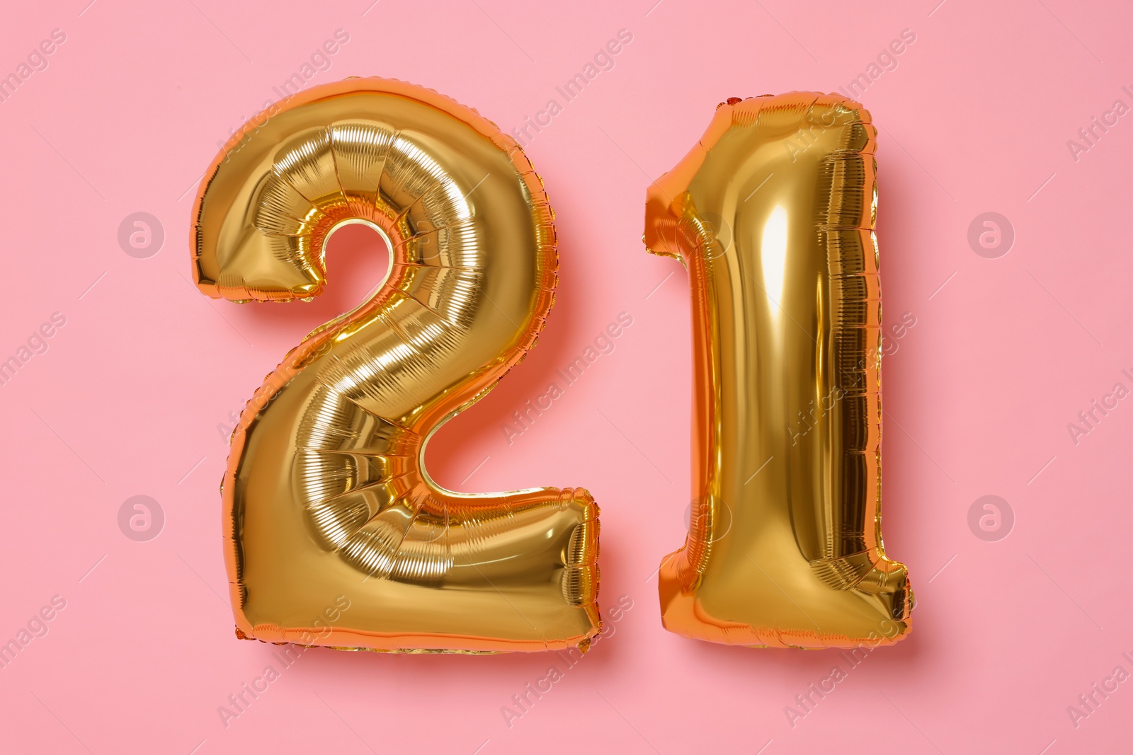 Photo of Coming of age party - 21st birthday. Number shaped balloons on pink background