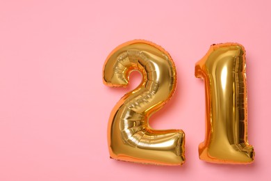 Photo of Coming of age party - 21st birthday. Number shaped balloons on pink background, space for text