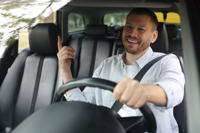 Photo of Man driving modern car, view through window