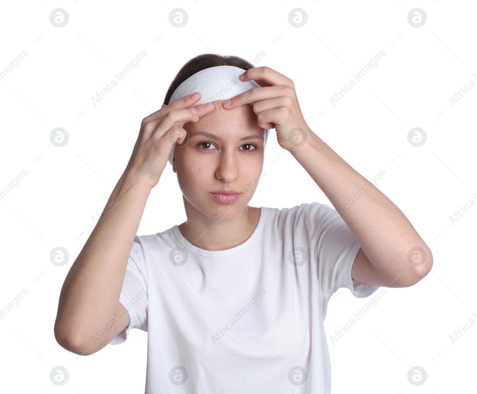 Photo of Teenage girl popping pimple on her face against white background. Acne problem