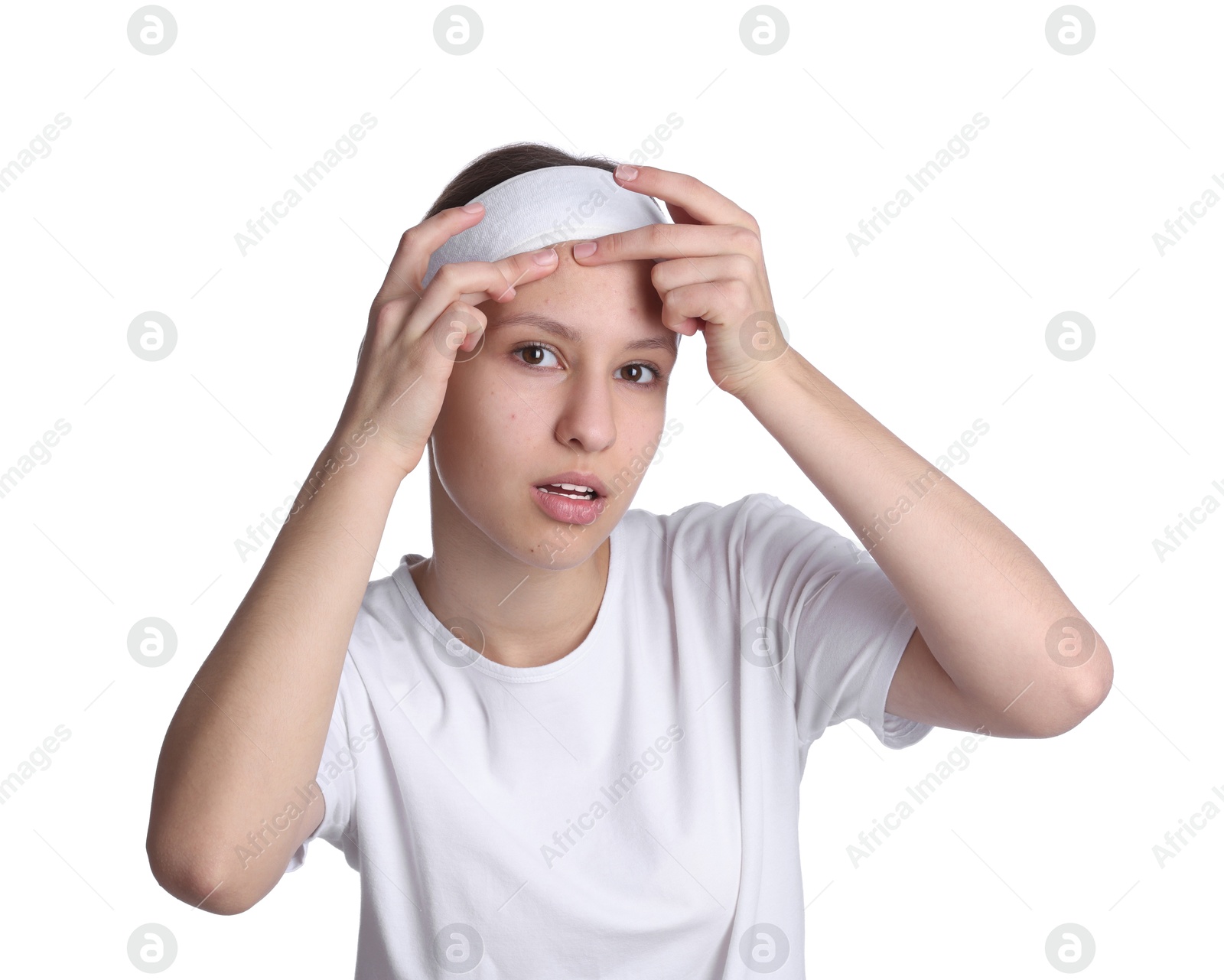 Photo of Teenage girl popping pimple on her face against white background. Acne problem