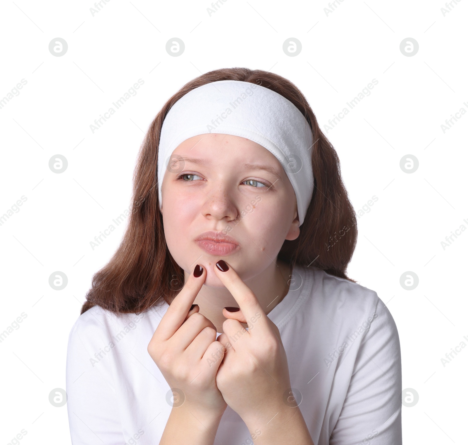 Photo of Teenage girl popping pimple on her face against white background. Acne problem