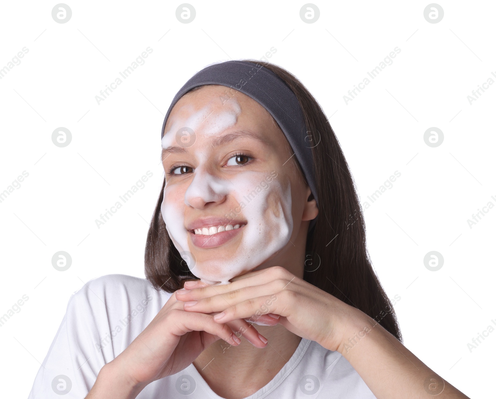 Photo of Teenage girl washing her face with cleanser on white background. Cosmetic product