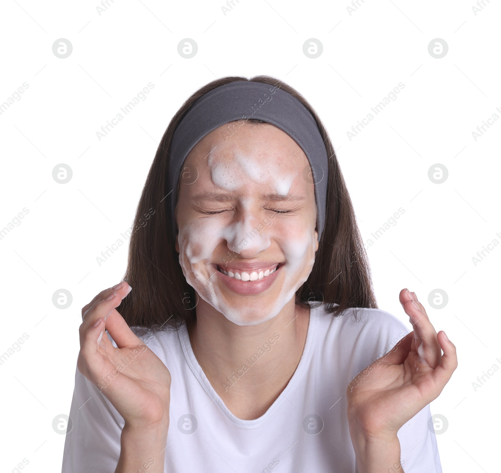 Photo of Teenage girl washing her face with cleanser on white background. Cosmetic product