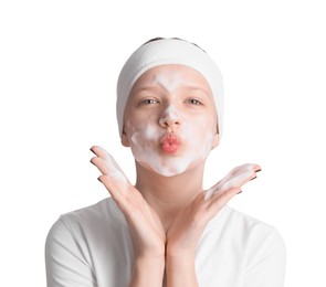 Photo of Teenage girl washing her face with cleanser on white background. Cosmetic product