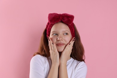 Photo of Portrait of teenage girl with headband on pink background