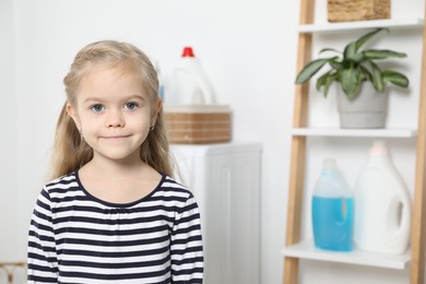 Photo of Little helper. Cute girl in bathroom, space for text