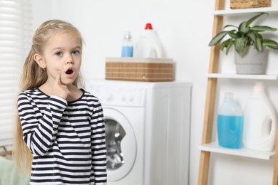 Photo of Little helper. Cute girl in bathroom, space for text