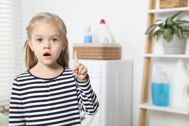 Photo of Little helper. Cute girl in bathroom, space for text