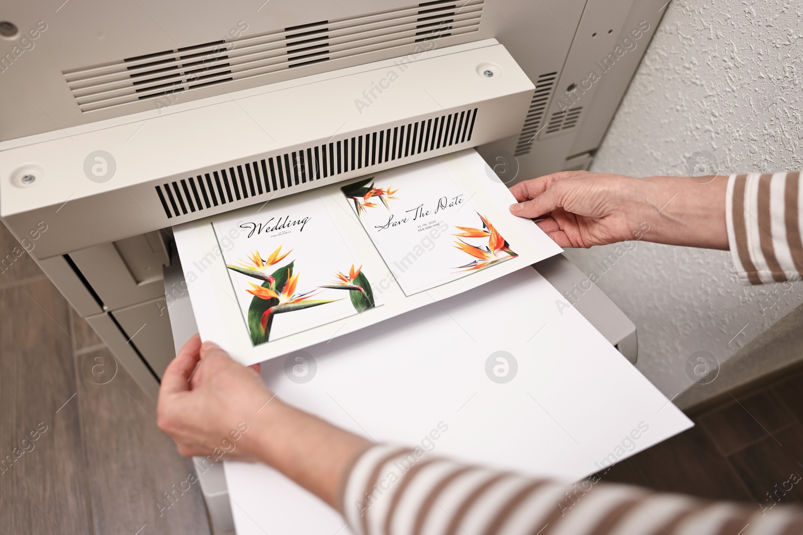 Photo of Woman using modern printer indoors, closeup. Printing house