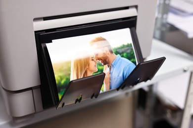 Photo of Modern printer with colorful photo indoors, closeup