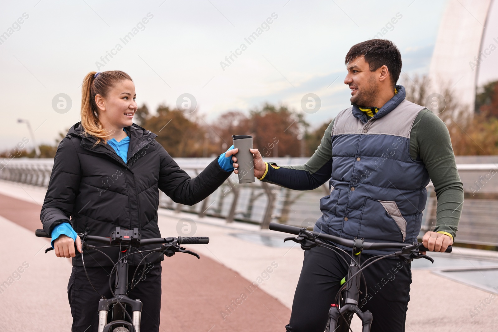 Photo of Beautiful happy couple with bicycles spending time together outdoors