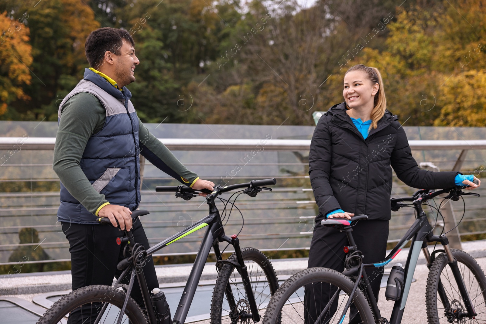 Photo of Beautiful happy couple with bicycles spending time together outdoors