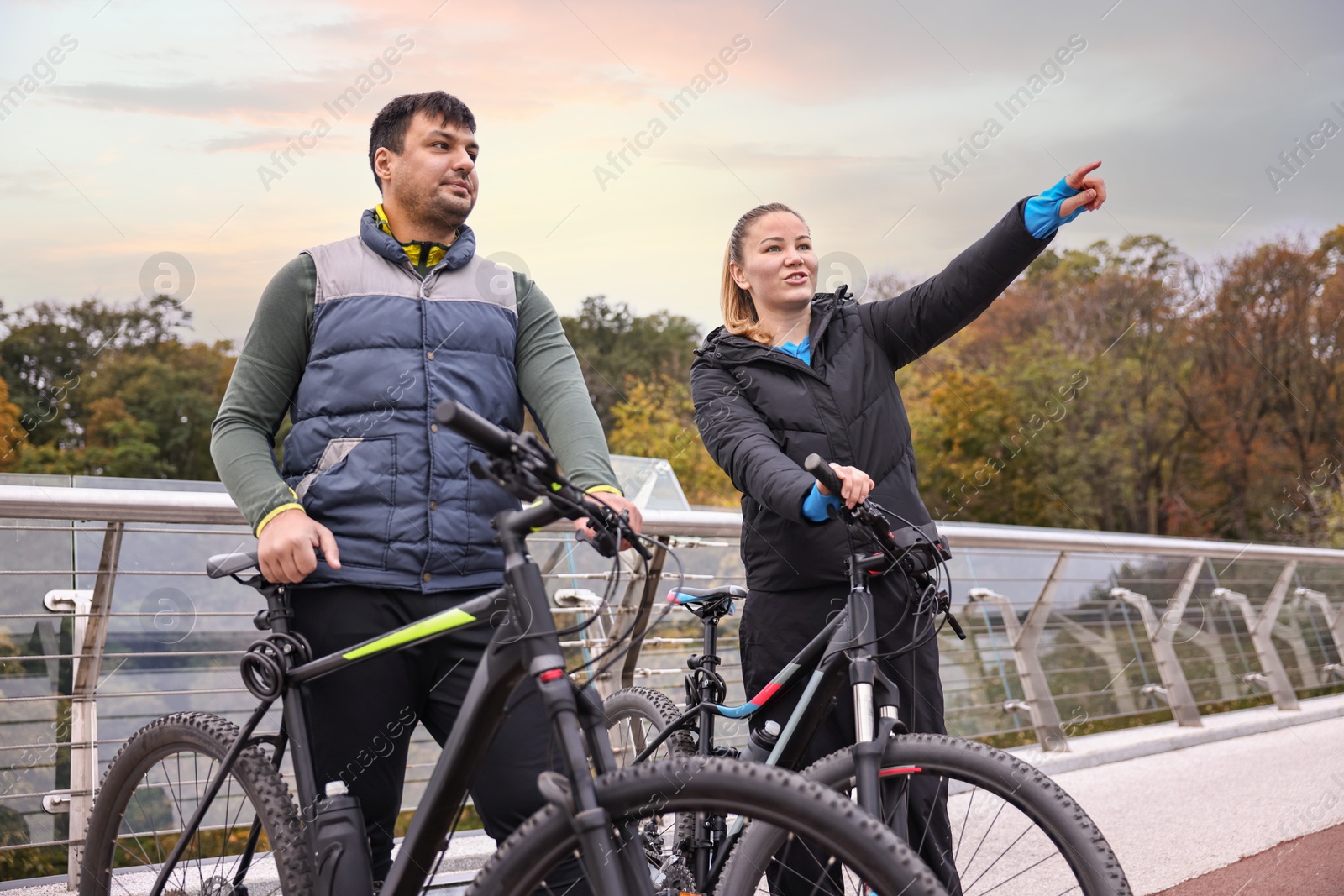 Photo of Beautiful happy couple with bicycles spending time together outdoors