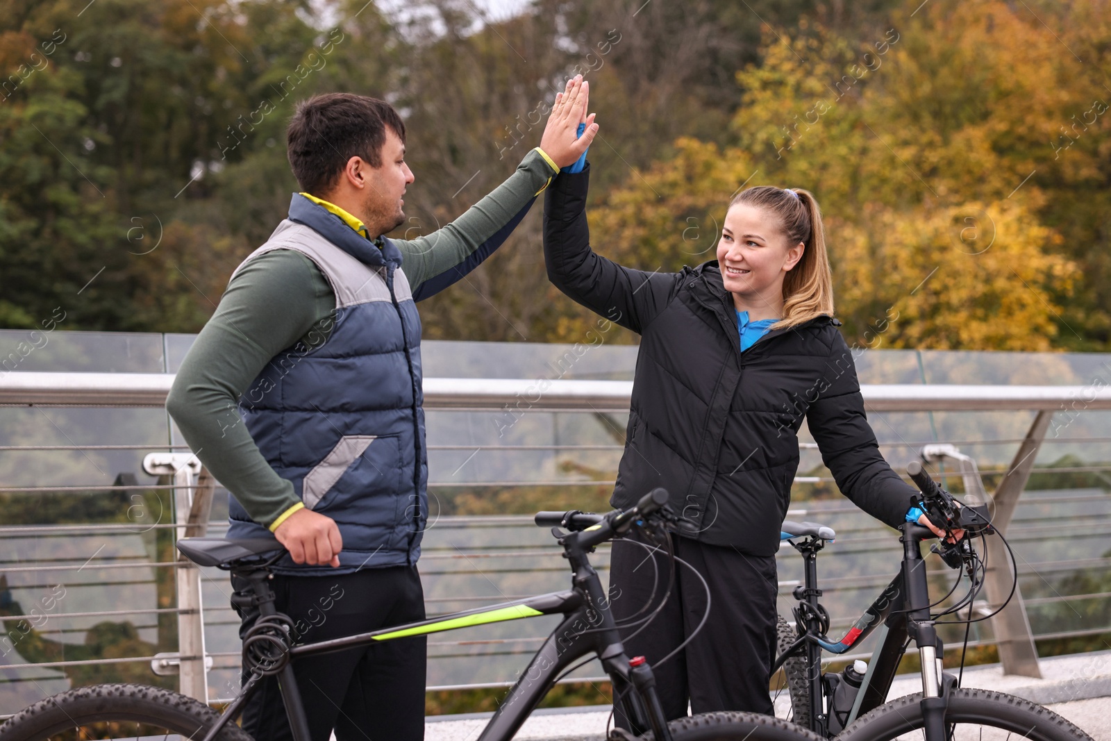 Photo of Beautiful happy couple with bicycles spending time together outdoors