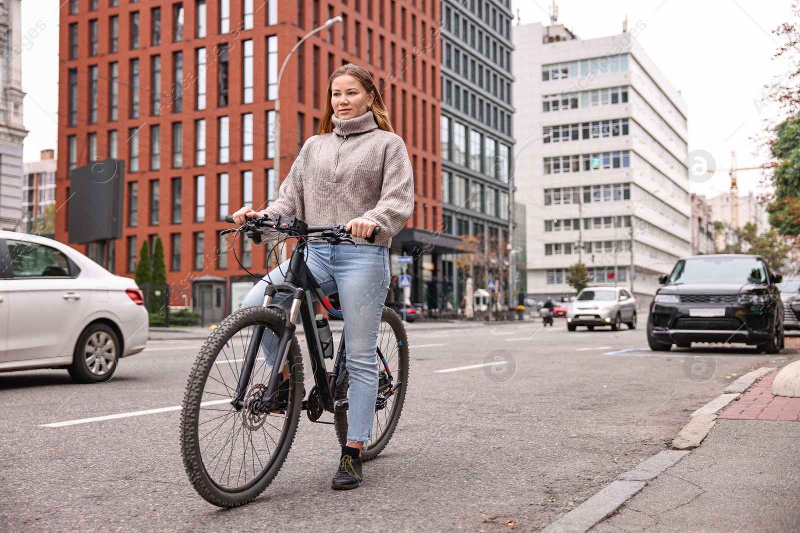 Photo of Woman with bicycle outdoors, space for text