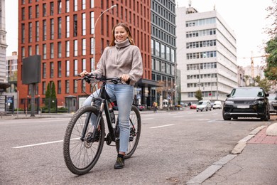 Photo of Woman with bicycle outdoors, space for text