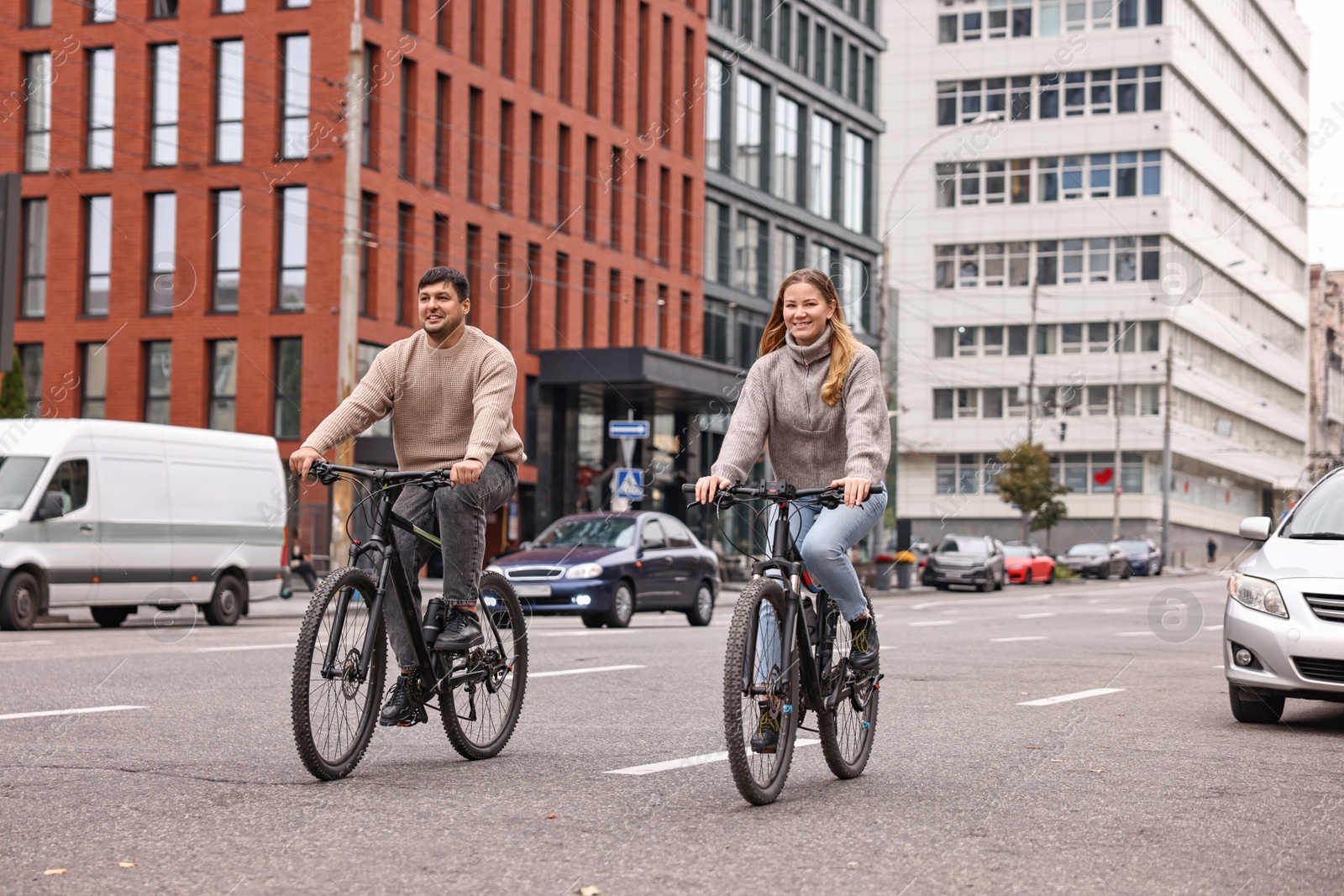 Photo of Beautiful happy couple riding bicycles and spending time together outdoors