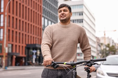 Photo of Handsome man with bicycle outdoors. Healthy lifestyle