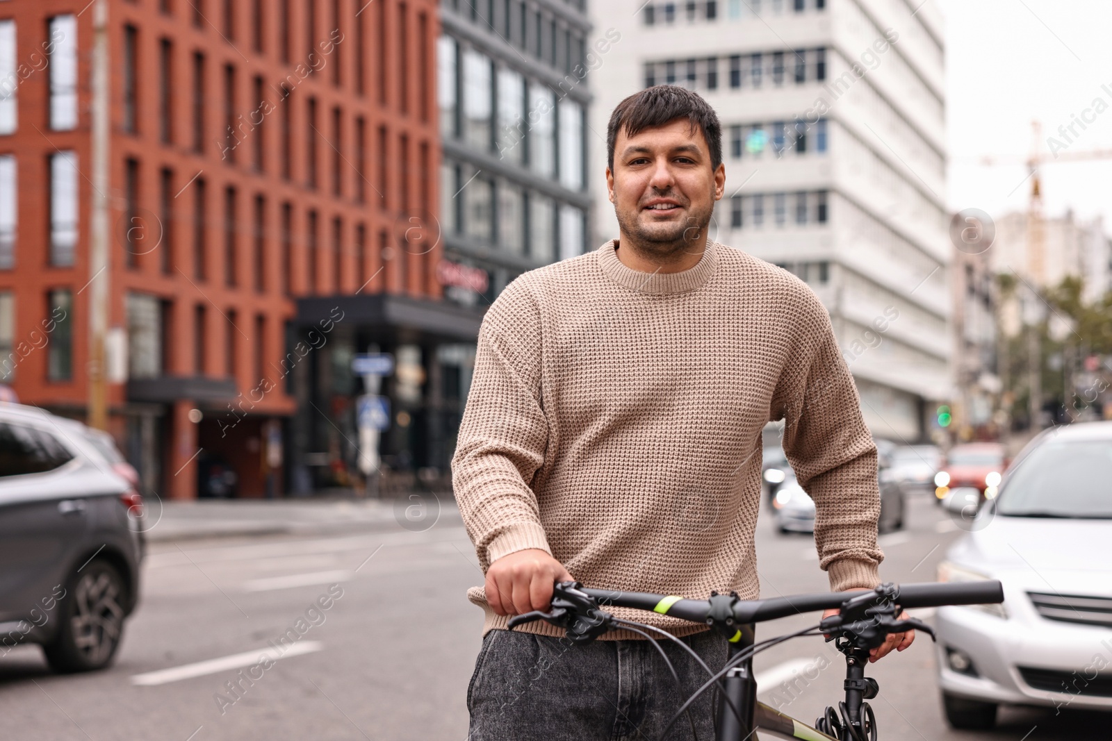 Photo of Man with bicycle outdoors, space for text