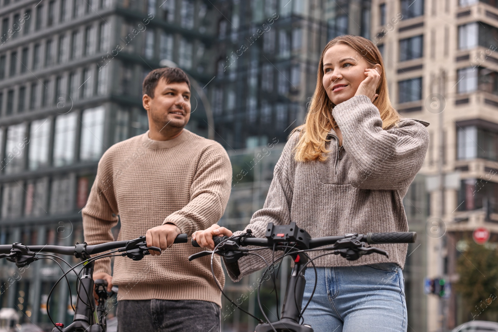 Photo of Beautiful happy couple with bicycles spending time together outdoors