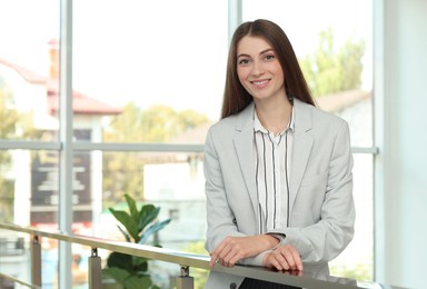 Portrait of happy banker in jacket indoors. Space for text