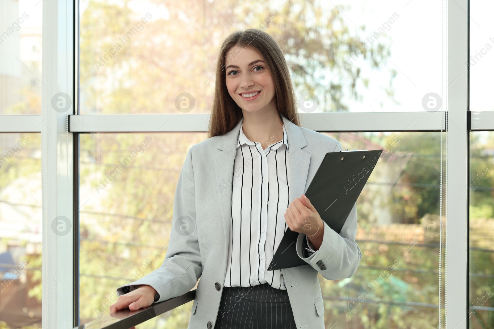 Photo of Portrait of banker with clipboard in office