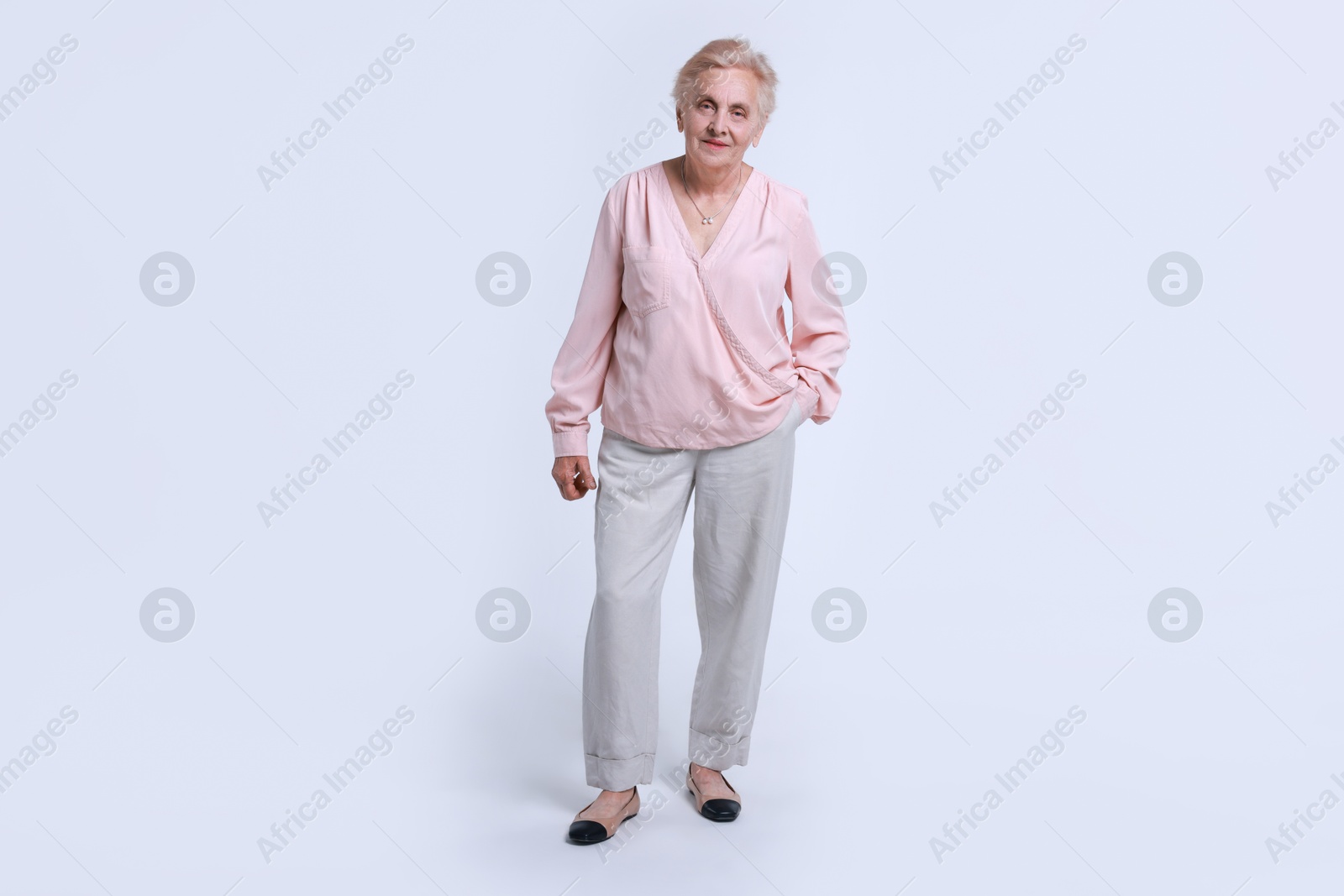 Photo of Full length portrait of senior woman on white background